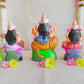 Handcrafted Navarathri Golu dolls of Durga, Lakshmi, and Saraswathi, beautifully painted and displayed with floral decorations.