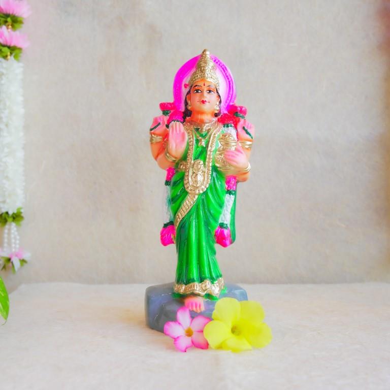 Handcrafted Navarathri Golu Doll of Vastu Lakshmi adorned in a vibrant green saree with intricate detailing, blessing devotees.