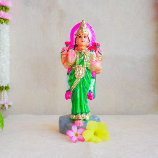 Handcrafted Navarathri Golu Doll of Vastu Lakshmi adorned in a vibrant green saree with intricate detailing, blessing devotees.