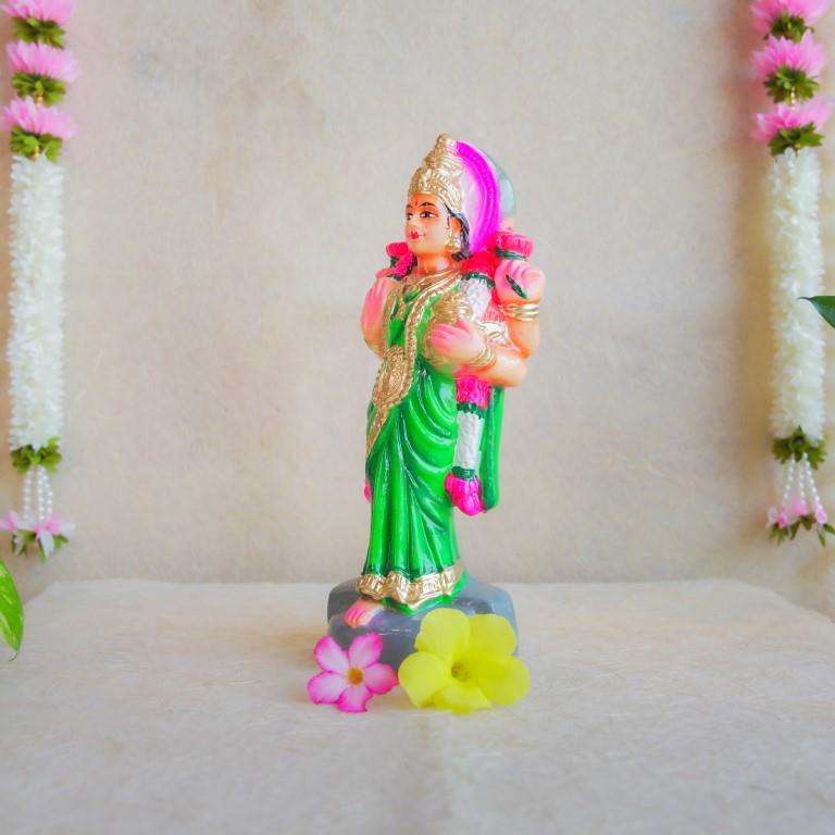 Handcrafted Navarathri Golu Doll of Vastu Lakshmi adorned in a vibrant green saree with intricate detailing, blessing devotees.