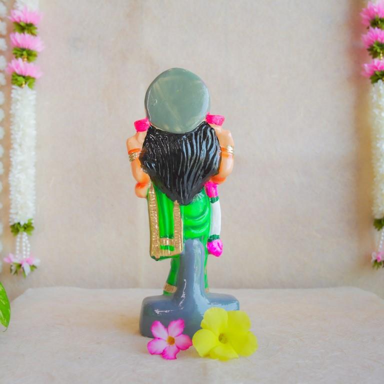 Handcrafted Navarathri Golu Doll of Vastu Lakshmi adorned in a vibrant green saree with intricate detailing, blessing devotees.