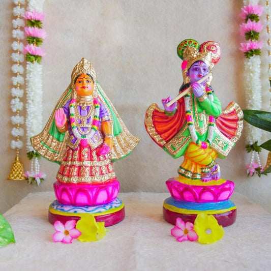 Handcrafted Navarathri Golu Dolls of Mathura Krishna playing flute and Rukmini in traditional attire, adorned with vibrant colors and intricate detailing.