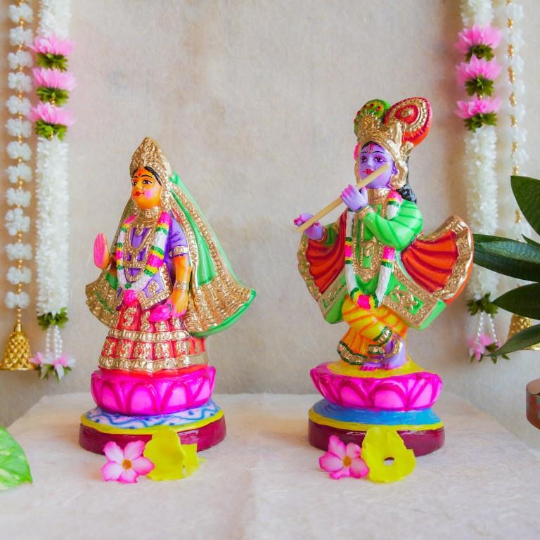 Handcrafted Navarathri Golu Dolls of Mathura Krishna playing flute and Rukmini in traditional attire, adorned with vibrant colors and intricate detailing.