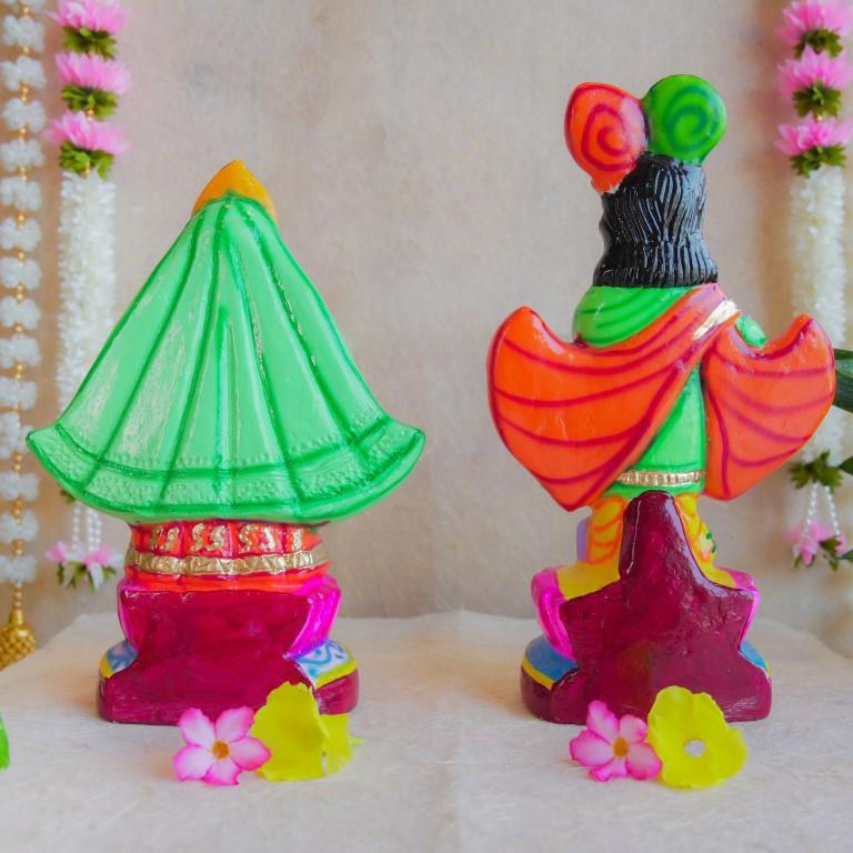 Handcrafted Navarathri Golu Dolls of Mathura Krishna playing flute and Rukmini in traditional attire, adorned with vibrant colors and intricate detailing.