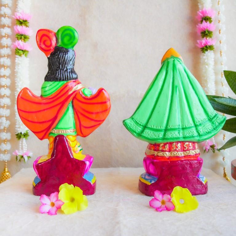 Handcrafted Navarathri Golu Dolls of Mathura Krishna playing flute and Rukmini in traditional attire, adorned with vibrant colors and intricate detailing.