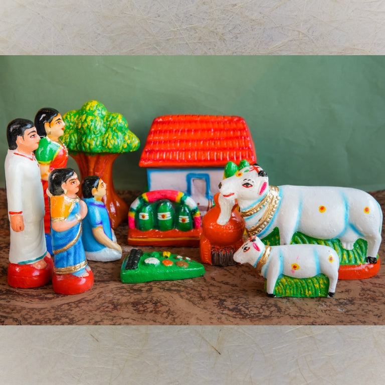 Handcrafted Pongal Celebration Navaratri Golu Doll Set with family, cows, a house, and a Pongal pot, intricately detailed and vibrantly colored.
