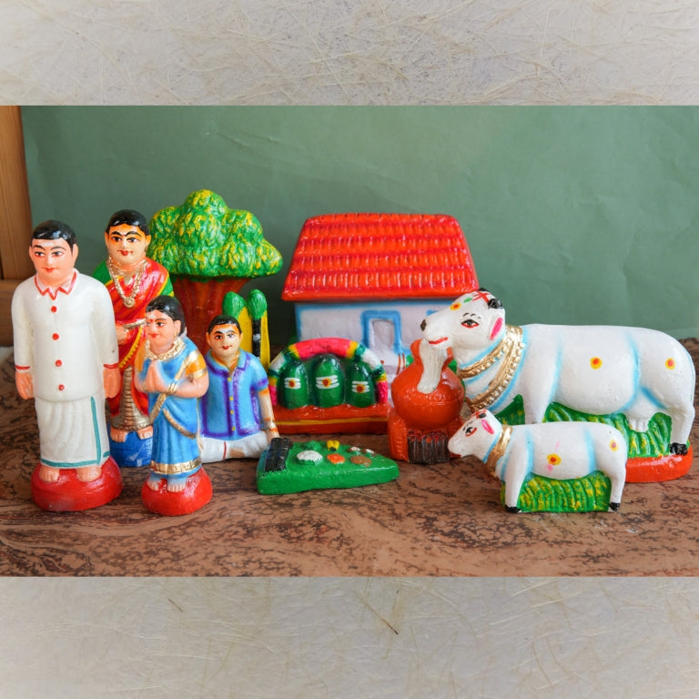 Handcrafted Pongal Celebration Navaratri Golu Doll Set with family, cows, a house, and a Pongal pot, intricately detailed and vibrantly colored.