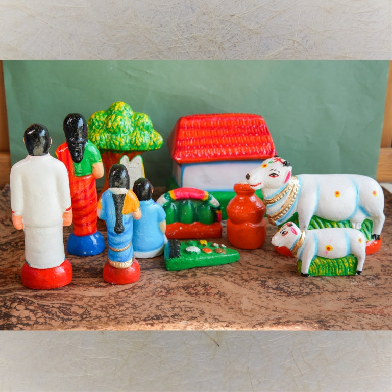 Handcrafted Pongal Celebration Navaratri Golu Doll Set with family, cows, a house, and a Pongal pot, intricately detailed and vibrantly colored.