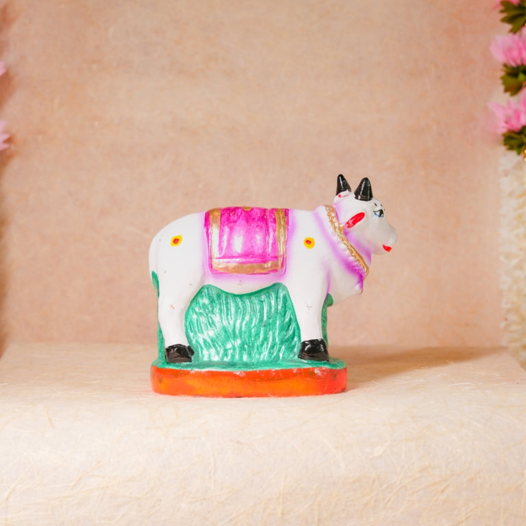 Handcrafted Navarathri Golu Kamadhenu figurine with vibrant detailing, featuring a sacred cow and calf, symbolizing abundance and prosperity.