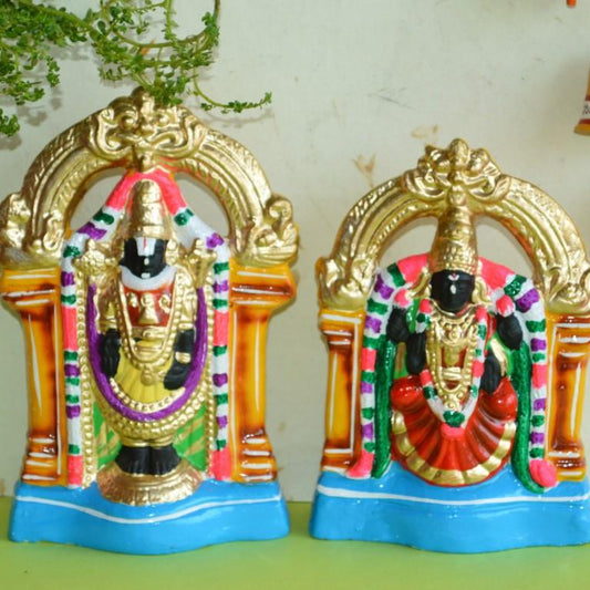Handcrafted Navaratri Golu dolls featuring Perumal (Lord Vishnu) and Thayaar (Goddess Lakshmi) in vibrant colors, seated within decorative temple frames.