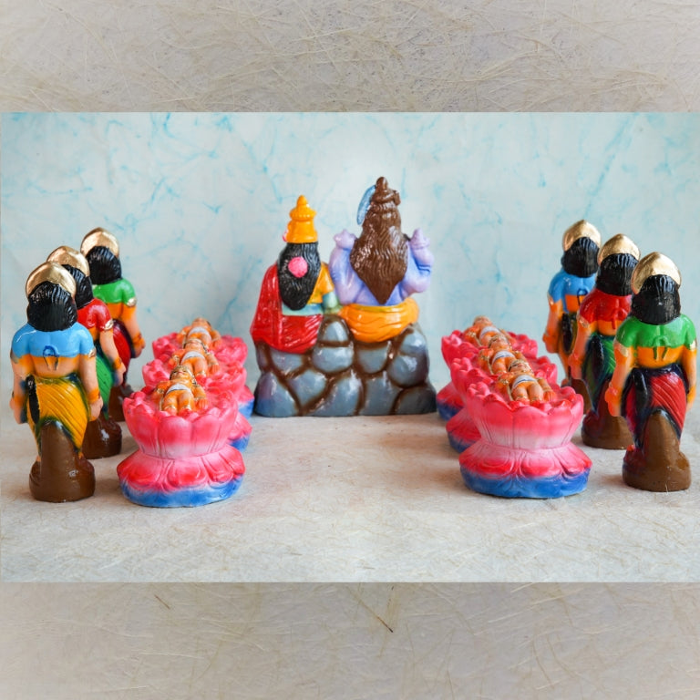 Handcrafted Karthigai Pengal set featuring celestial caretakers with Lord Shiva, Goddess Parvati, and infant Muruga, ideal for Navaratri Golu displays.
