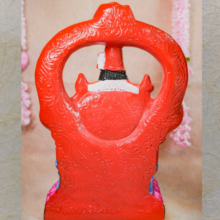 Handcrafted Bhuvaneshwari Amman Golu doll with vibrant colors and intricate throne design, displayed with floral decor.