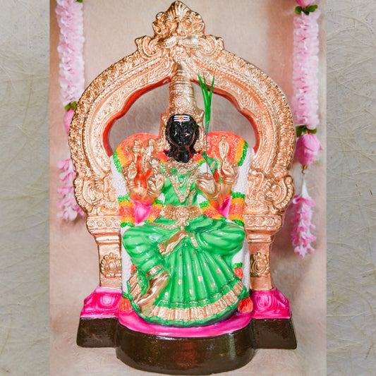 Handcrafted Navarathri Golu doll of Goddess Kalikambal in a seated posture with a green saree and gold-decorated throne.