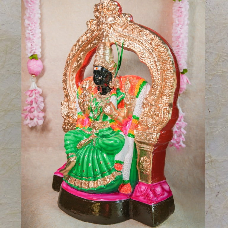 Handcrafted Navarathri Golu doll of Goddess Kalikambal in a seated posture with a green saree and gold-decorated throne.