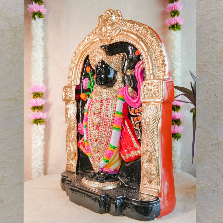 Handcrafted Navarathri Golu doll of Lord Krishna in Dwaraka, adorned with vibrant pink, gold, and black detailing under a decorative arch.