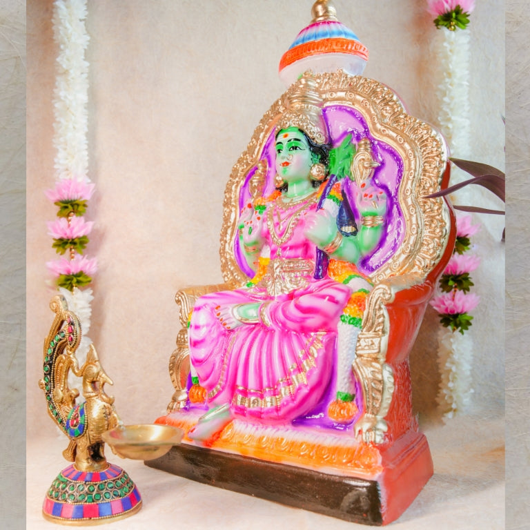 Handcrafted Navarathri Golu doll of Goddess Rajeshwari seated on a golden throne with vibrant pink and green accents.