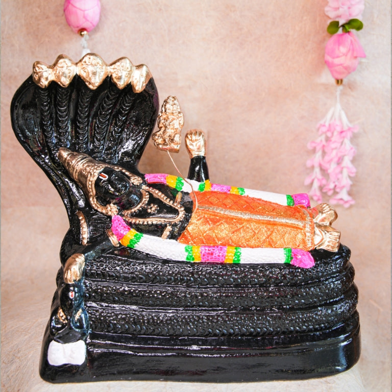 Handcrafted Navarathri Golu doll of Lord Ranganathar reclining on Adisesha with black and gold detailing.