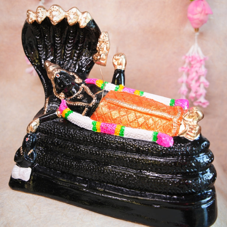 Handcrafted Navarathri Golu doll of Lord Ranganathar reclining on Adisesha with black and gold detailing.