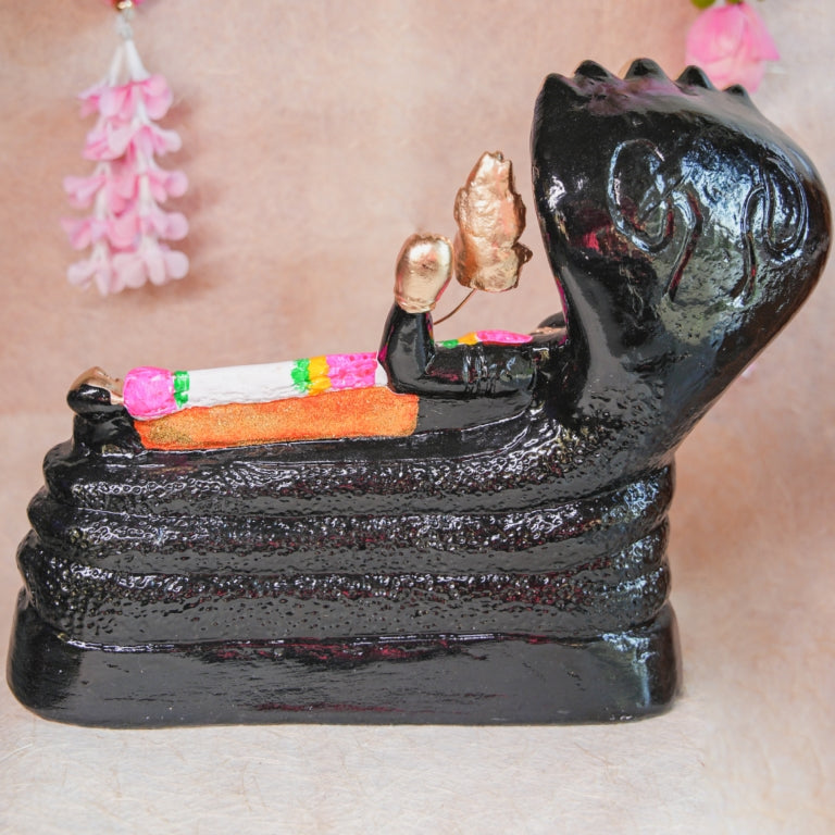 Handcrafted Navarathri Golu doll of Lord Ranganathar reclining on Adisesha with black and gold detailing.