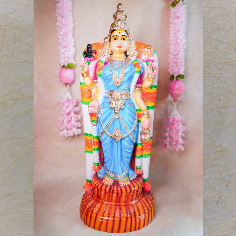 Handcrafted Navarathri Golu doll of Goddess Vishalakshi in a vibrant blue dress, adorned with intricate jewelry and floral garlands.