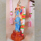Handcrafted Navarathri Golu doll of Goddess Vishalakshi in a vibrant blue dress, adorned with intricate jewelry and floral garlands.