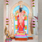 Handcrafted Navarathri Golu doll of Goddess Abirami adorned in a vibrant red saree with intricate jewelry, set within a decorative arch.