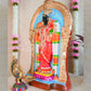Handcrafted Navarathri Golu doll of Goddess Abirami adorned in a vibrant red saree with intricate jewelry, set within a decorative arch.