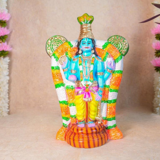 Handcrafted Navarathri Golu doll of Guruvayurappan in vibrant colors with intricate detailing and a snake hood backdrop.