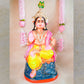 Handcrafted clay doll of Lord Murugan seated in a regal posture, dressed in vibrant colors, perfect for Navarathri Golu decor.