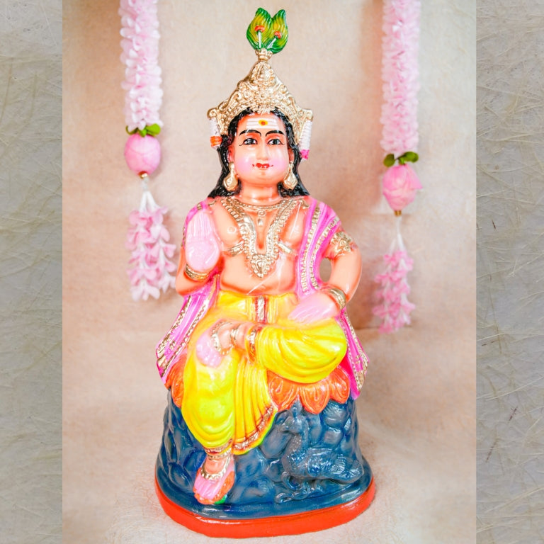 Handcrafted clay doll of Lord Murugan seated in a regal posture, dressed in vibrant colors, perfect for Navarathri Golu decor.