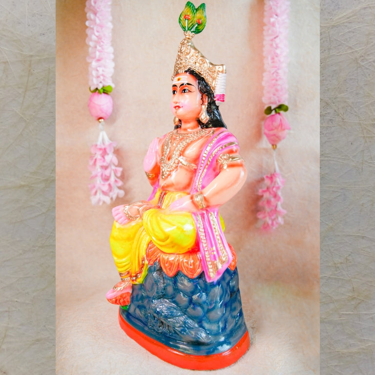 Handcrafted clay doll of Lord Murugan seated in a regal posture, dressed in vibrant colors, perfect for Navarathri Golu decor.