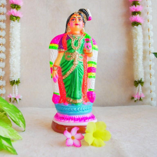 Hand-painted Navarathri Golu Doll of Andal, adorned in a green saree and colorful garlands, symbolizing divine grace and devotion.