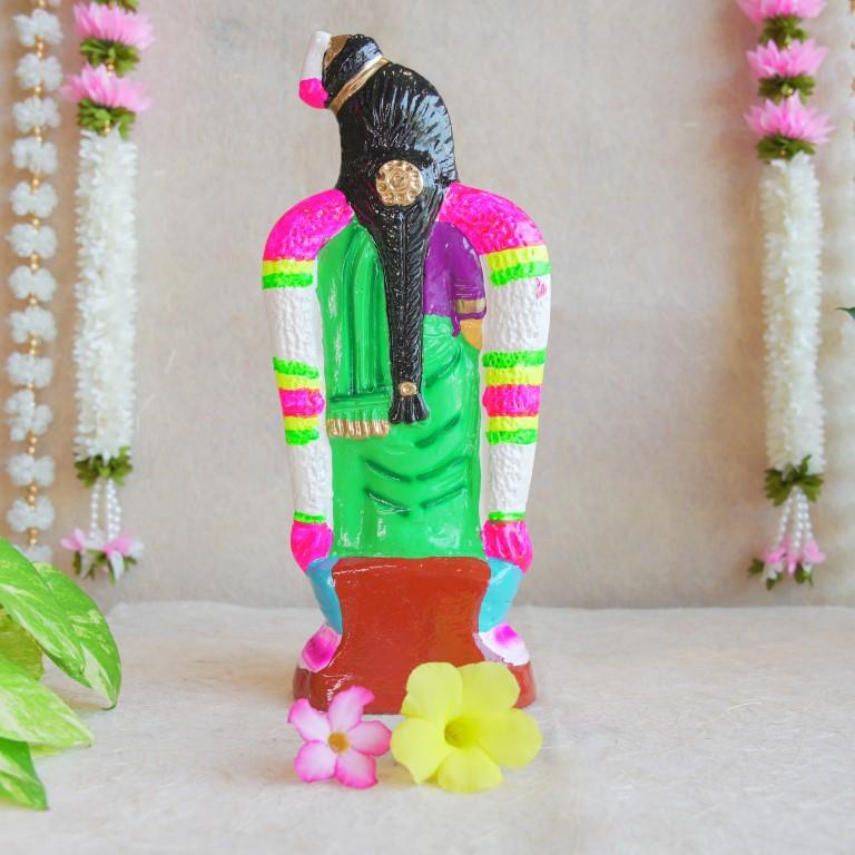 Hand-painted Navarathri Golu Doll of Andal, adorned in a green saree and colorful garlands, symbolizing divine grace and devotion.