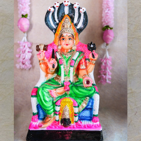 Hand-painted Navarathri Golu Doll of Goddess Karumari Amman seated under a five-headed serpent, symbolizing divine protection and grace.