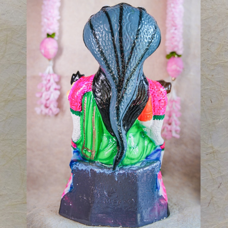Hand-painted Navarathri Golu Doll of Goddess Karumari Amman seated under a five-headed serpent, symbolizing divine protection and grace.