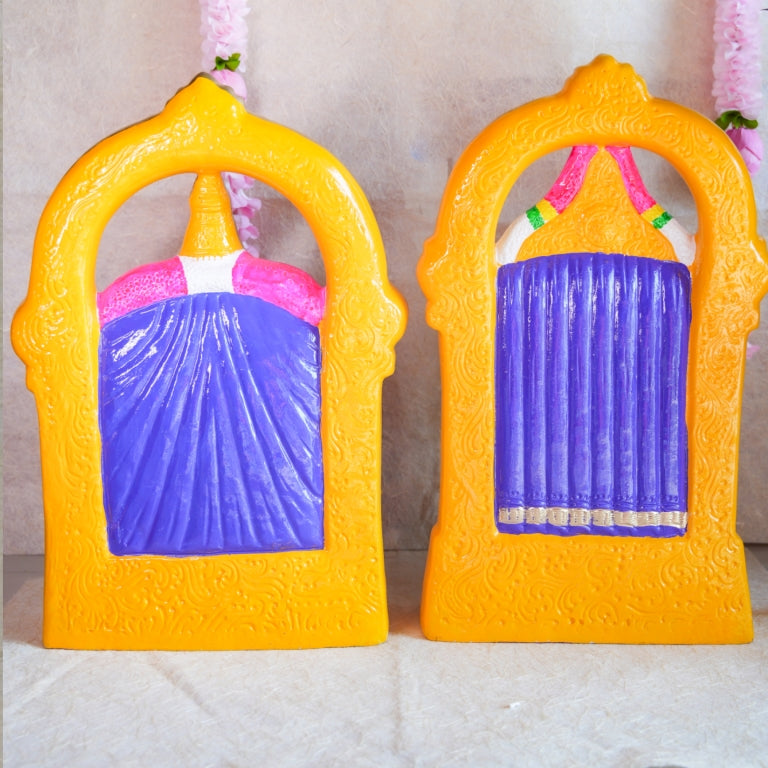 Navarathri Golu Dolls featuring Perumal and Thaayar seated within ornate arches, hand-painted with vibrant traditional colors.