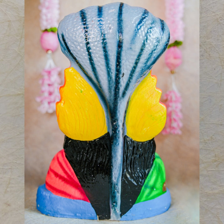 Hand-painted Navarathri Golu Doll of Karumari Amman Bust with vibrant colors, cobra hood, and traditional ornamentation.
