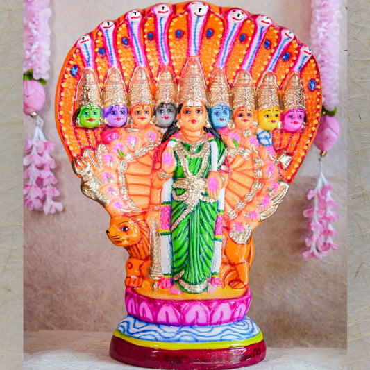 Handcrafted Navarathri Golu Doll of Nava Durga under a serpent canopy, adorned in vibrant colors with a lion mount.