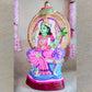 Handcrafted Navarathri Golu Doll of Goddess Rajeshwari seated on a throne with an ornamental umbrella, featuring vibrant colors and intricate details.