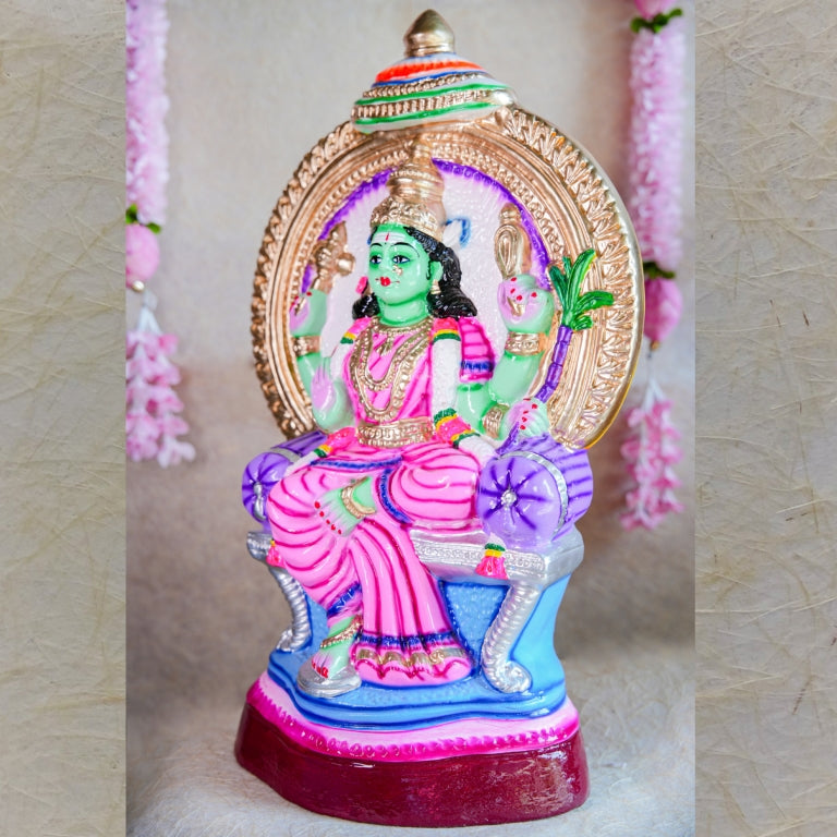 Handcrafted Navarathri Golu Doll of Goddess Rajeshwari seated on a throne with an ornamental umbrella, featuring vibrant colors and intricate details.