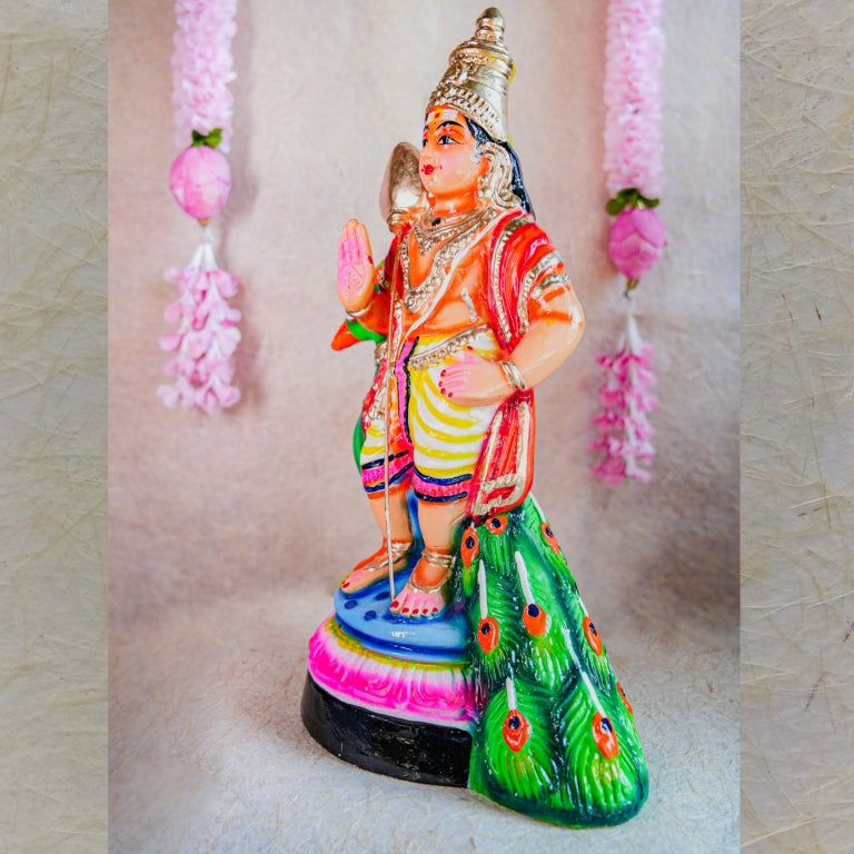 Handcrafted Navarathri Golu Doll of Lord Murugan standing beside a colorful peacock with intricate detailing.