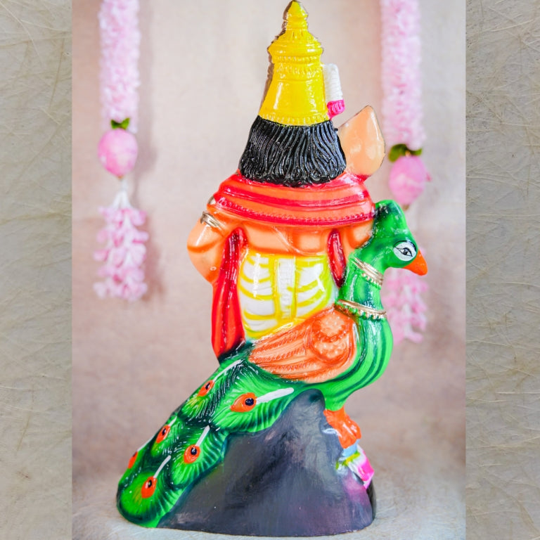 Handcrafted Navarathri Golu Doll of Lord Murugan standing beside a colorful peacock with intricate detailing.