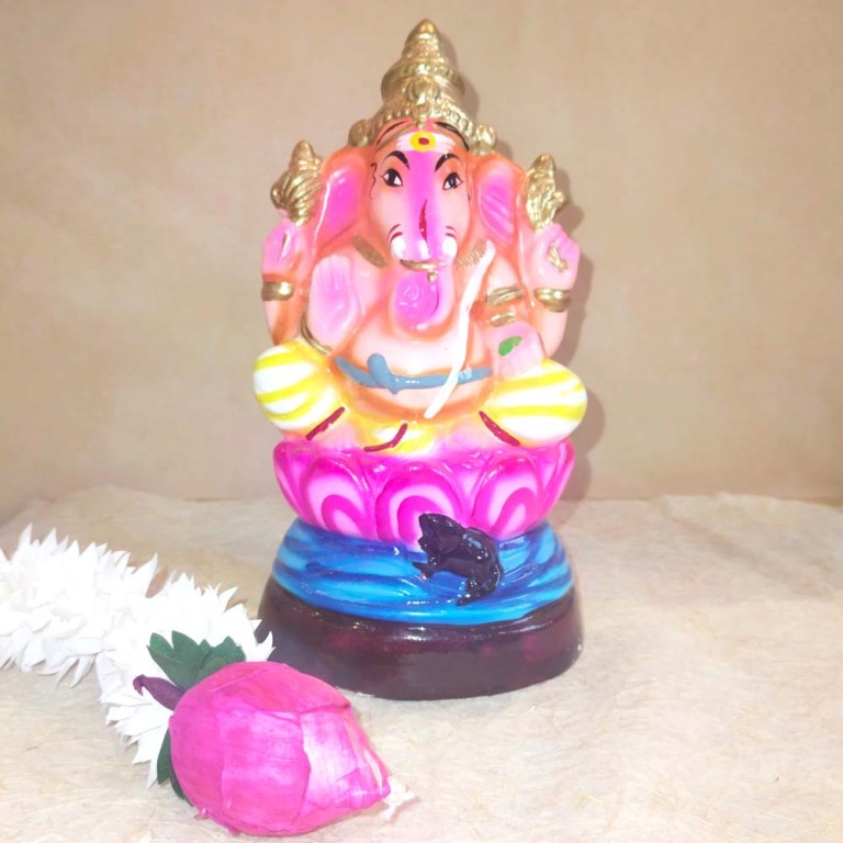 Handcrafted Navarathri Golu Doll of Lord Ganesh seated on a pink lotus base with vibrant colors and intricate gold accents.