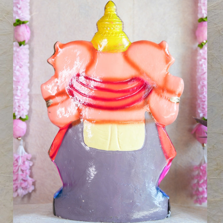 Handcrafted Navarathri Golu Doll of Lord Ganesh in vibrant pink, orange, and gold, seated on a lotus base.
