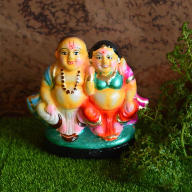 Handcrafted Navarathri Golu dolls featuring a cheerful Mama Mami couple in traditional South Indian attire.