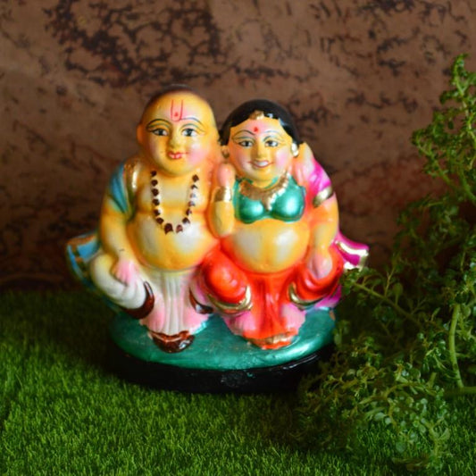 Handcrafted Navarathri Golu dolls featuring a cheerful Mama Mami couple in traditional South Indian attire.