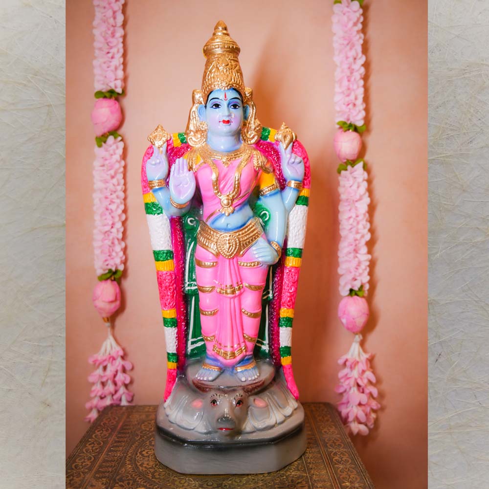 Handcrafted Durga Vishnu idol in vibrant pink and blue, adorned with intricate detailing, standing gracefully on a pedestal.