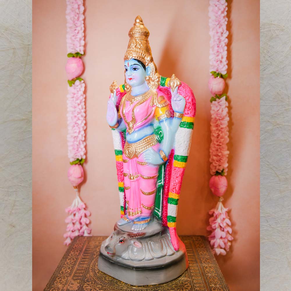 Handcrafted Durga Vishnu idol in vibrant pink and blue, adorned with intricate detailing, standing gracefully on a pedestal.