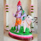 Handcrafted Krishna Mannarkudi Rajagopalan Navaratri Golu Doll with vibrant colors and intricate detailing, featuring cows and divine symbolism.