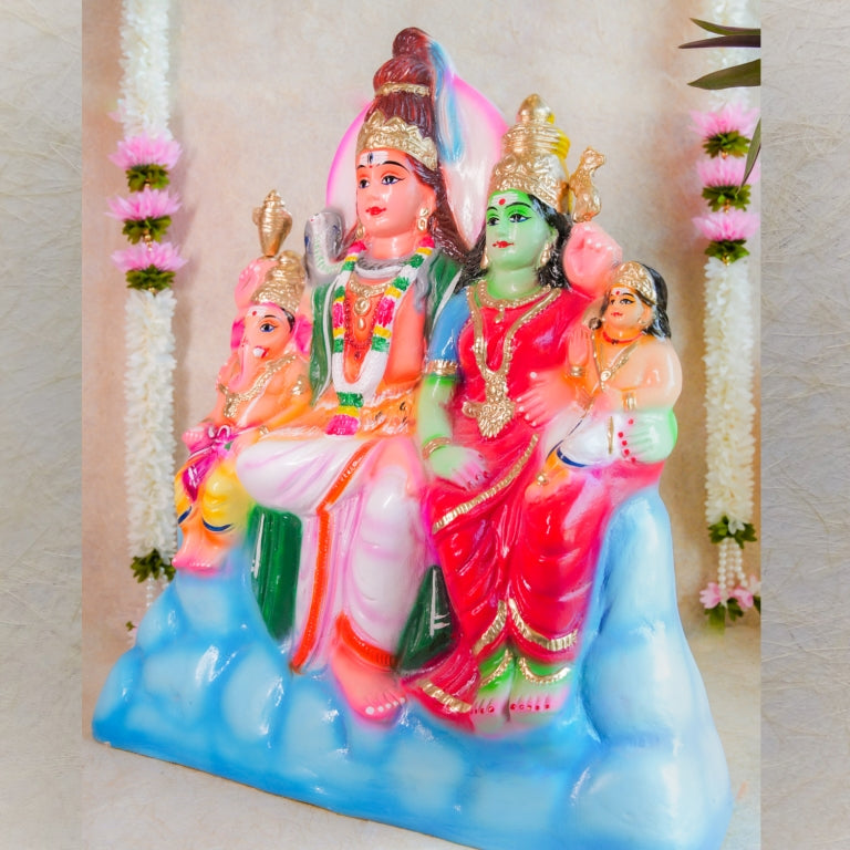 Handcrafted Navarathri Golu doll set depicting the Shiva family, vibrantly painted and adorned with floral decorations.